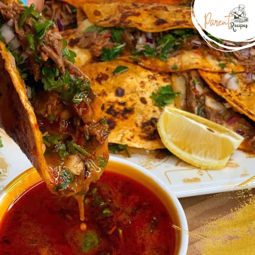 Birria tacos with beef, topped with cilantro and onions, served with a side of consomé