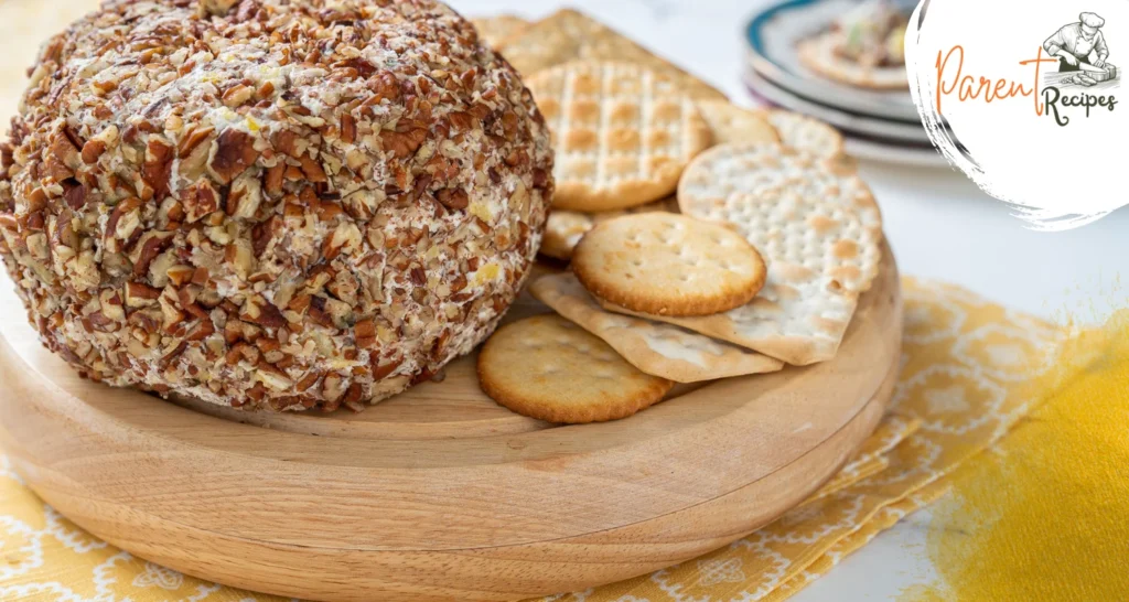 A flat lay image of the core ingredients needed for the Cheese Ball Recipe: cream cheese, cheddar cheese, Worcestershire sauce, garlic powder, chopped green onions, and pecans. Each ingredient is neatly arranged on a kitchen countertop, ready for preparation, visually reinforcing the simplicity of the recipe