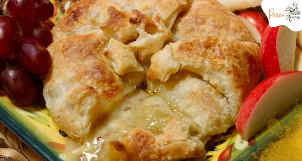 Sliced Baked Brie in Puff Pastry showing gooey cheese and flaky crust