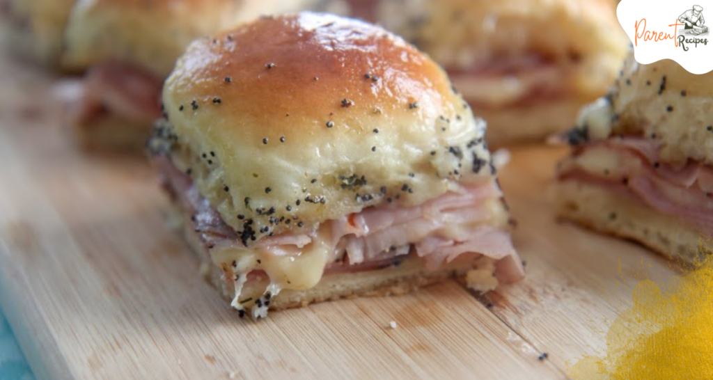 Ham and cheese sliders served on a platter, perfect for parties and game days.